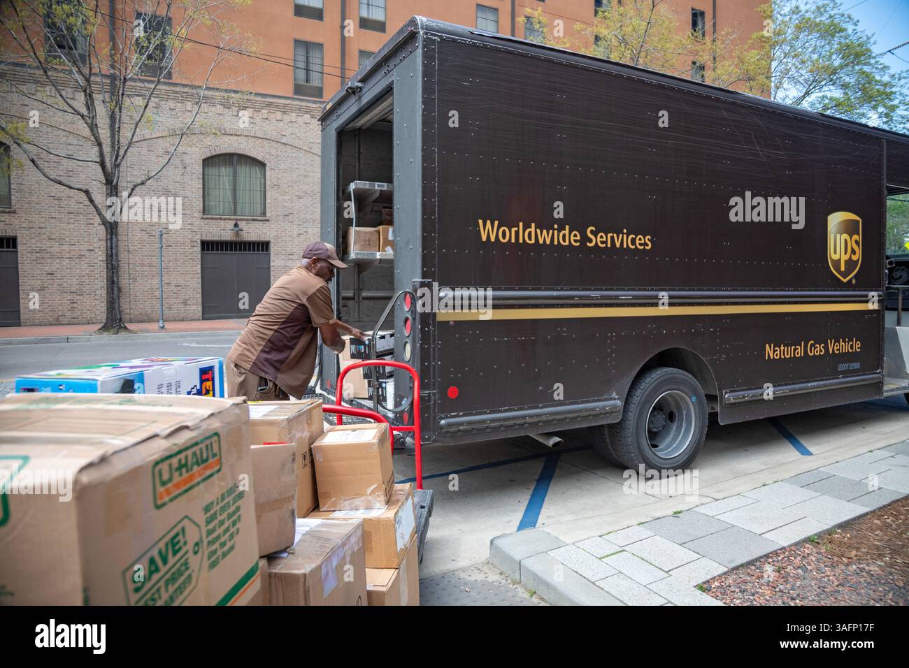 New Orleans, Louisiana - Un conducente della United Parcel Service carica i pacchi nella sua "package car" al New Orleans Convention Center. Il suo veicolo è POW Foto Stock