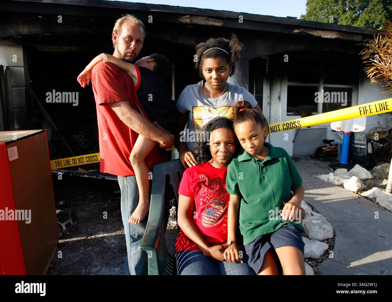 1- DIDASCALIA: (SEMINOLE 09/08/08) . La famiglia Twigg di fronte alla loro casa che è stata distrutta da un incendio elettrico la scorsa settimana che è iniziato nella soffitta della loro casa a Seminole (09/07/08). Nella foto (da sinistra) è Tony Twigg (cq), 29 anni, con suo figlio addormentato Pierce Twigg (cq), 4 anni, insieme alla figlia Mikayla Sanders (cq), 12 anni, e sua moglie Nadia Twigg (cq), 31 anni, seduta con la figlia Alexis Twigg (Credit Image: St Petersburg Times/ZUMAPRESS.com) Foto Stock