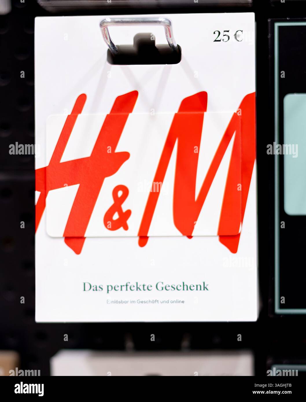 Una vivace carta regalo H e M con un'audace tipografia rossa, ideale come regalo per gli amanti della moda e dello shopping. - FRANCOFORTE, GERMANIA - 21 MARZO 2025 Foto Stock