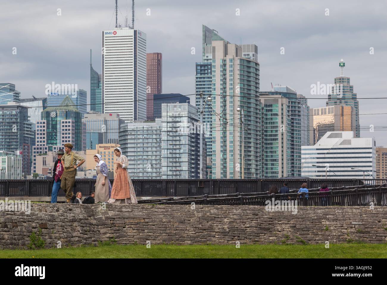 TORONTO, ONT, CANADA- 27 MAGGIO 2017: Il personale si veste in costumi nel sito storico nazionale di Fort York con la città sullo sfondo. Foto Stock
