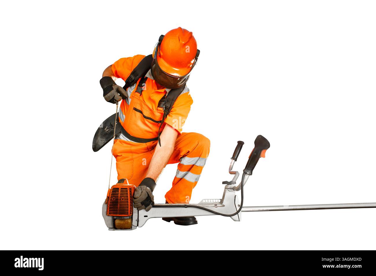 Lavoratore su strada in un dispositivo di sicurezza che avvia un decespugliatore per la manutenzione Foto Stock