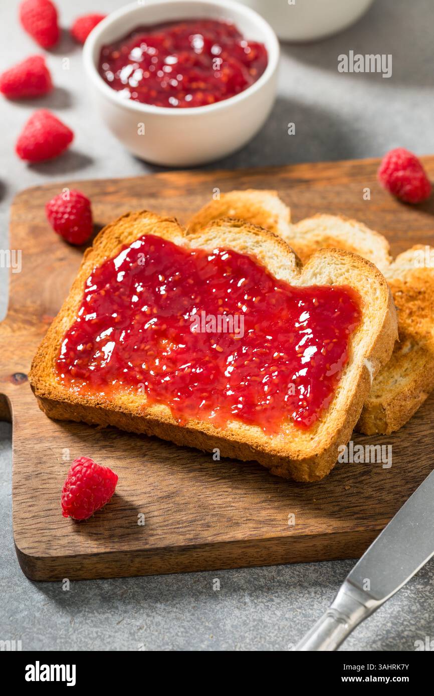 Gelatina fatta in casa con marmellata di lamponi e toast per colazione Foto Stock
