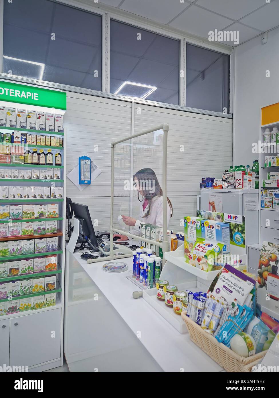 UNGHENI, MOLDAVIA - 17 DICEMBRE 2023 Visualizza all'interno della farmacia con farmacista sul posto di lavoro che legge prescrizione medica. Sanità e cosmetici - Immagine stock catturata con smartphone