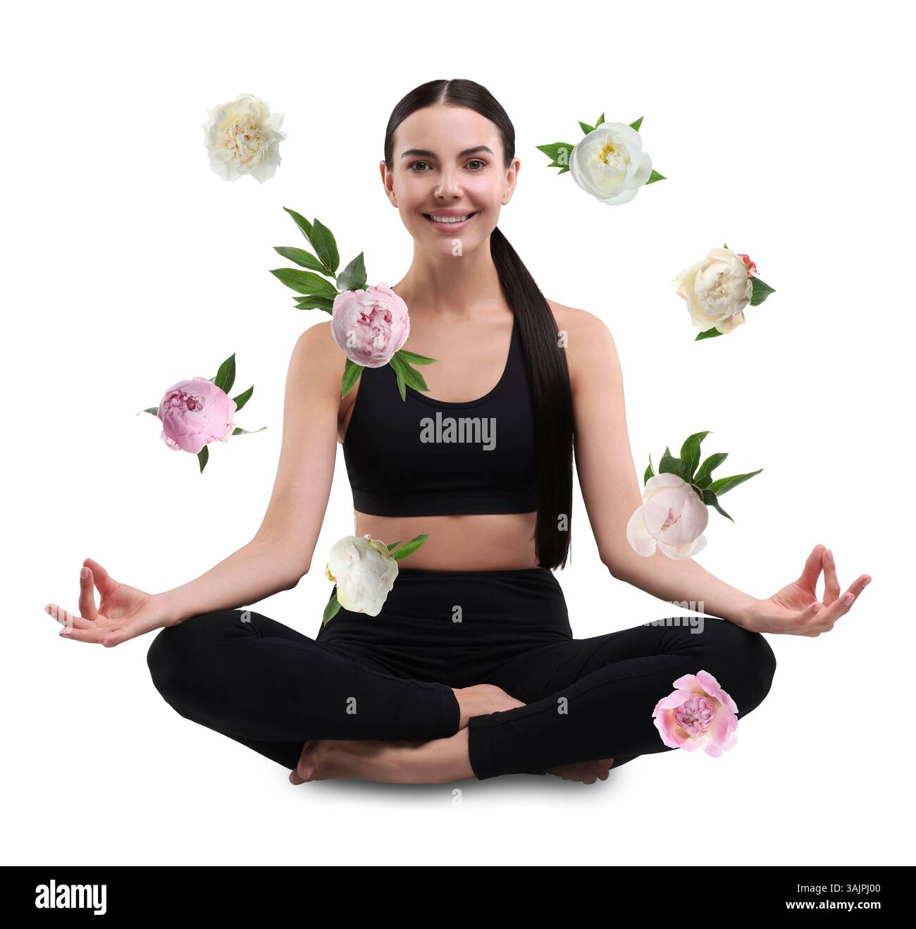Bella giovane donna che pratica yoga circondata da fiori volanti su sfondo bianco Foto Stock