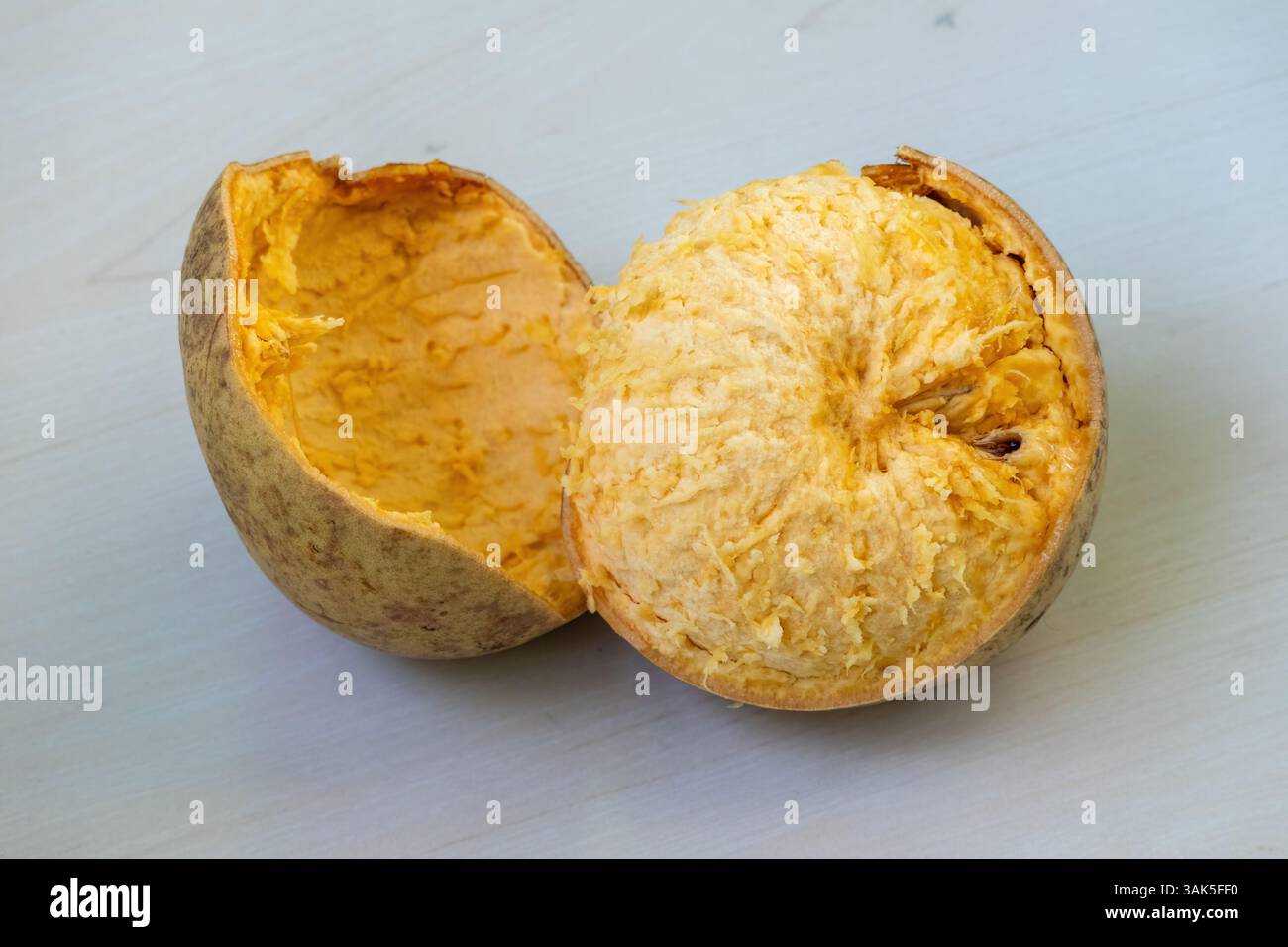 La mela di legno maturo o la frutta al barba vengono mostrate aperte per rivelare il suo interno succoso. Il suo nome scientifico è Aegle marmelos, ed è anche conosciuto come Foto Stock