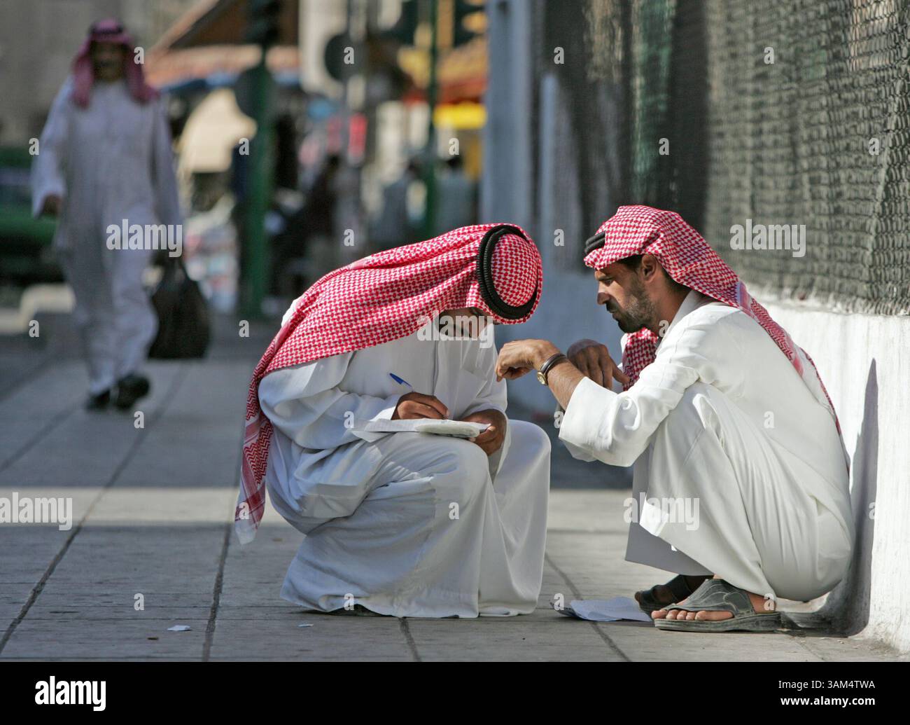 31 LUGLIO 2004 - STATI UNITI - FOTO DI: ALLISON LONG/KANSAS CITY STAR .092404. (l-r) Abu Hazem e Abu Mahdi scrivono una lettera ai familiari iracheni ad Amman in Giordania venerdì. I due attendono con ansia il venerdì insieme a migliaia di altri rifugiati iracheni perché ricevono e inviano posta alla famiglia in Iraq. Molti rifugiati non possono permettersi un telefono, quindi questa è l'unica forma di comunicazione. (Immagine di credito: © Allison Long/mct/ZUMAPRESS.com) Foto Stock