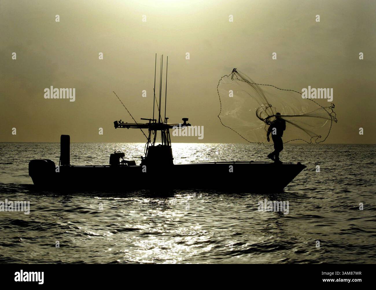 15 giugno 2006 - Stati Uniti - il capitano Jimmy Lewis lancia una rete dalla sua barca al largo di Key Biscayne, Florida, nel giugno 2006. Lewis trascorre le prime ore del mattino a pescare pesci esche e poi li vende ad altri che si dirigono verso la giornata. (Patrick Farrell/Miami Herald/MCT) (immagine di credito: © Patrick Farrell/mct/ZUMAPRESS.com) Foto Stock