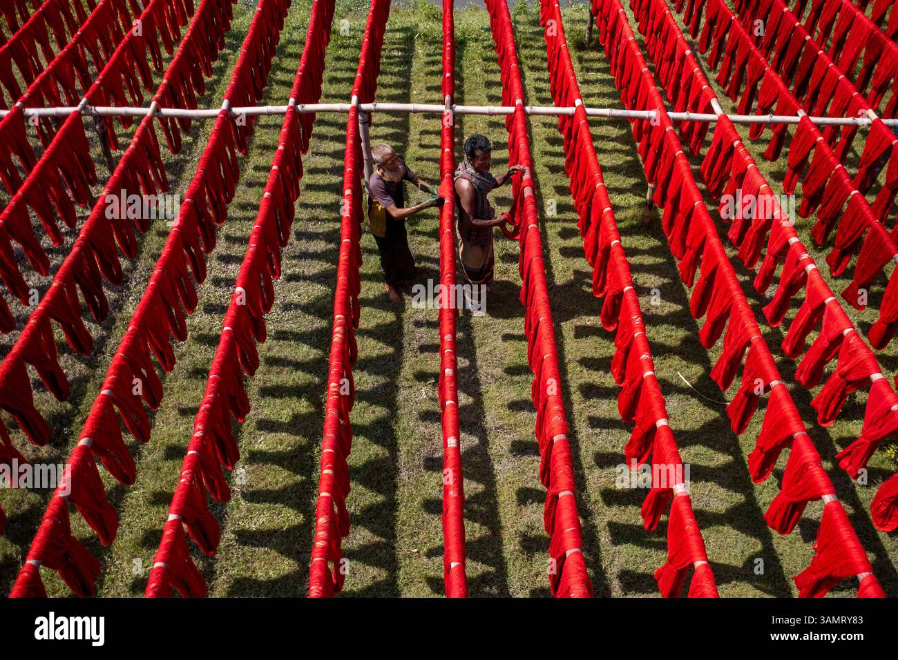 Dhaka, Bangladesh - 18 maggio 2021: Veduta aerea dei lavoratori che appendono tessuti colorati per magliette da asciugare a Narayanganj, Dhaka, Bangladesh. Foto Stock