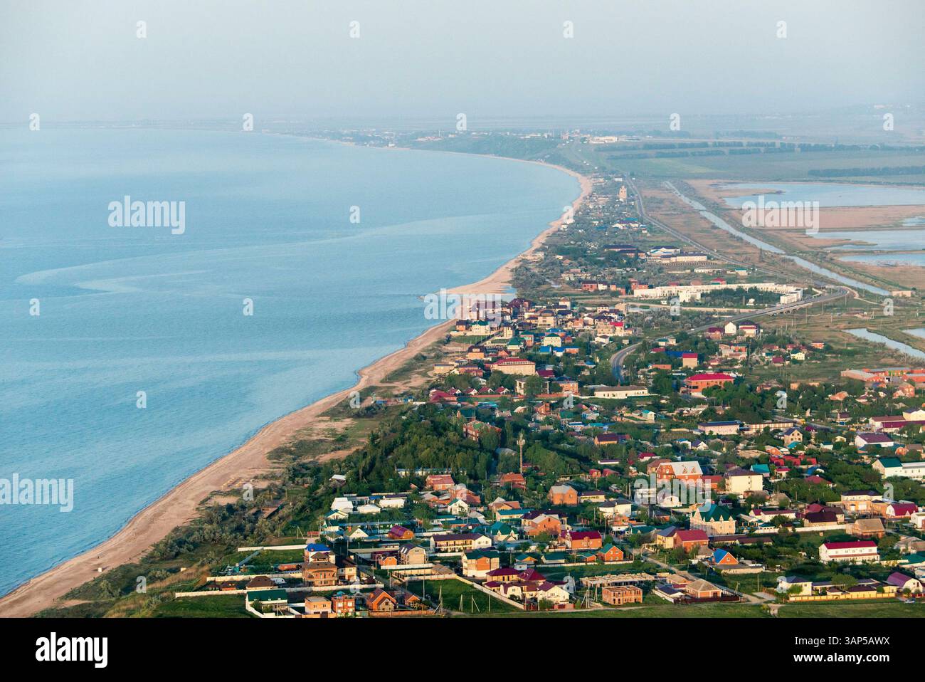 Vista aerea di una splendida costa con un tranquillo villaggio e spiaggia sabbiosa, Golubitskaya, Russia. Foto Stock