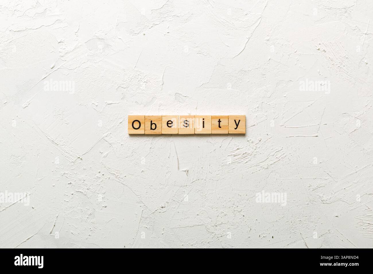 Parola di obesità scritta su blocco di legno. Testo di obesità sulla tabella del cemento per il vostro desing, concetto. Foto Stock