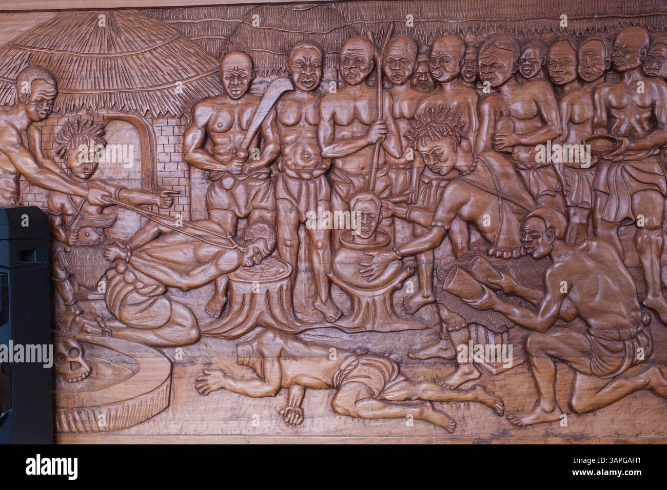 Winneba, Ghana. Wood Carvinmg mostra sacrificio umano all'interno del Centro visitatori per il Winneba Posuban, Un tradizionale Santuario della cultura Akan. Foto Stock