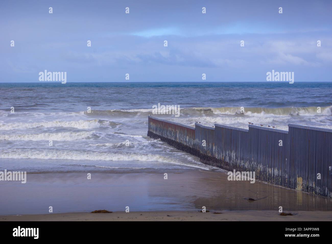 Il muro di confine tra Stati Uniti e Messico, spesso chiamato "muro di Trump", si estende lungo la spiaggia del Pacifico di Tijuana, rappresentando problemi complessi di immigrazione. Foto Stock