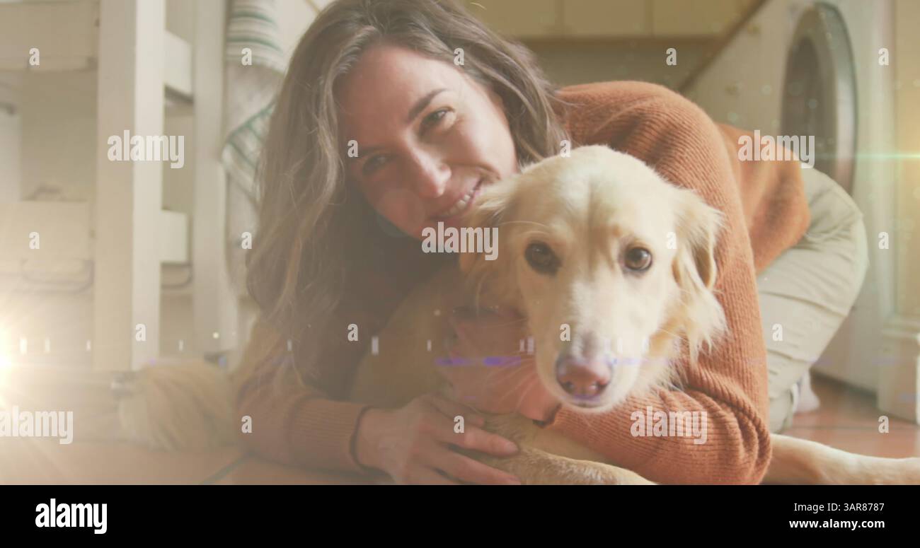 Un punto di luce contro una donna caucasica che gioca con il suo cane a casa Foto Stock
