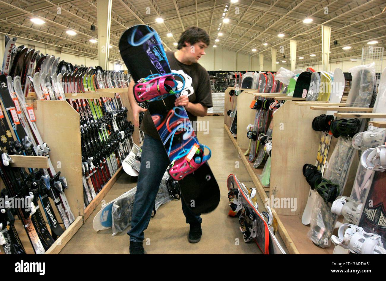 13 gennaio 2010 - del Mar, California, Stati Uniti - 13 gennaio 2010 del Mar, California, USA nella sala espositiva della zona fieristica JARRETT RUSSELL mette gli snowboard in espositori mentre lui e altri si preparano per la Mega sale di questa settimana che inizia giovedì e va fino a domenica. Jarett lavora per Hughes Ski Hut, di Chico, California, uno dei venditori dello spettacolo. Credito fotografico obbligatorio: CHARLIE NEUMAN/San Diego Union-Tribune/ZUMA Press (immagine di credito: © The San Diego Union-Tribune/ZUMApress.com) Foto Stock