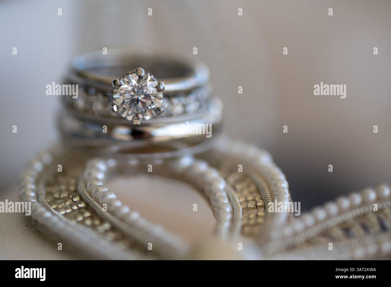 Primo piano dell'anello di fidanzamento con diamanti impilato con le feste nuziali Foto Stock