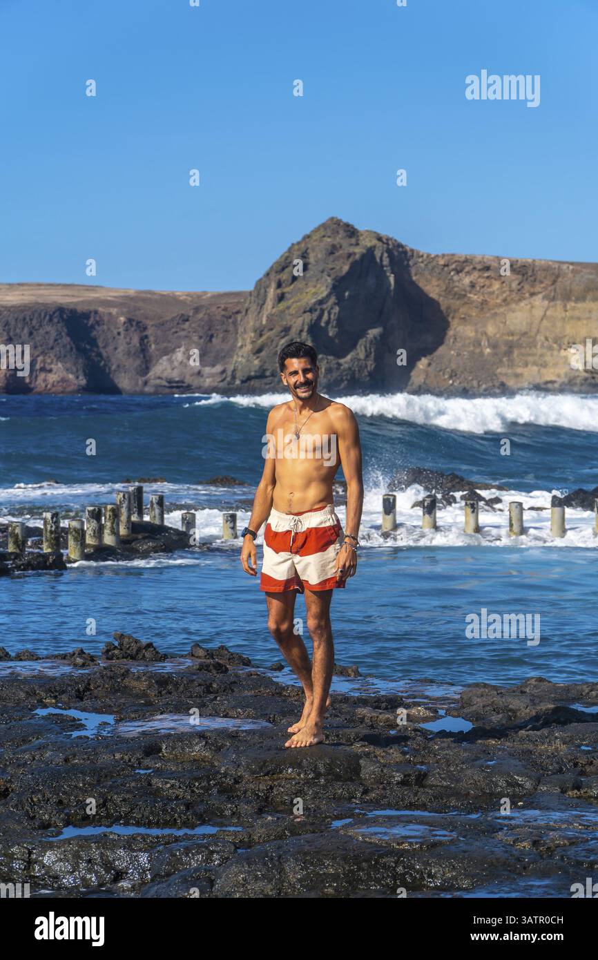 Giovane che gode delle vacanze estive sulla costa vulcanica di agaete, un'affascinante cittadina di gran canaria, Isole canarie, spagna Foto Stock