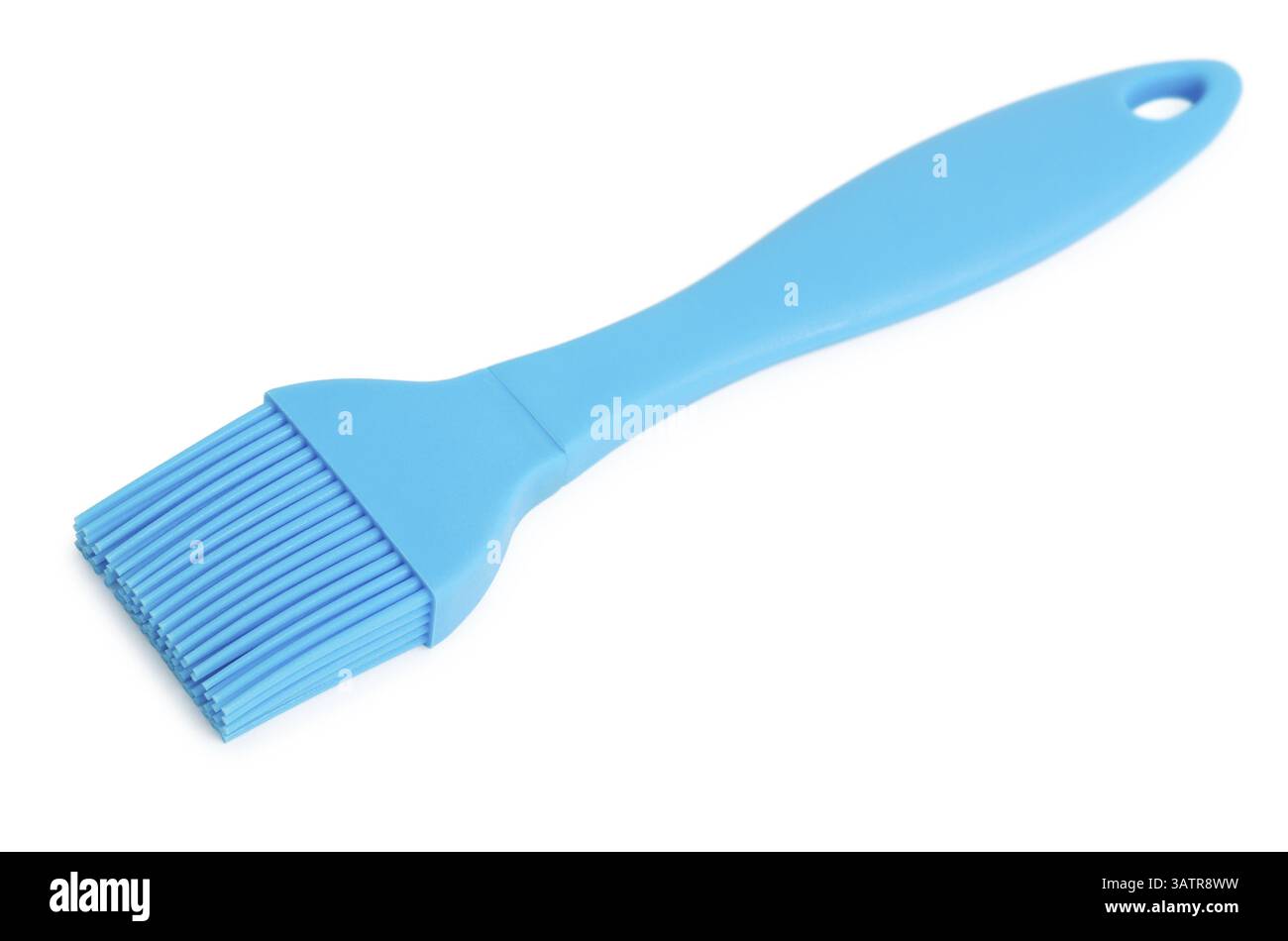 Una spazzola da cucina in silicone blu, su bianco Foto Stock