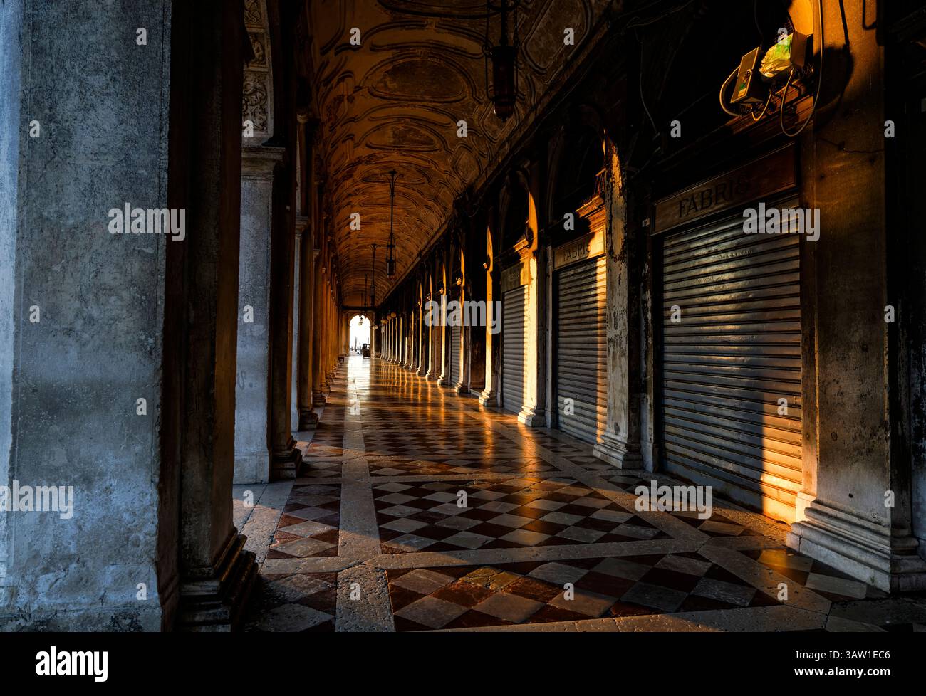 Alba nei negozi della galleria colonnata sotto la Biblioteca Marciana in stile rinascimentale veneziano in Piazza San Marco, San Marco, Venezia Foto Stock