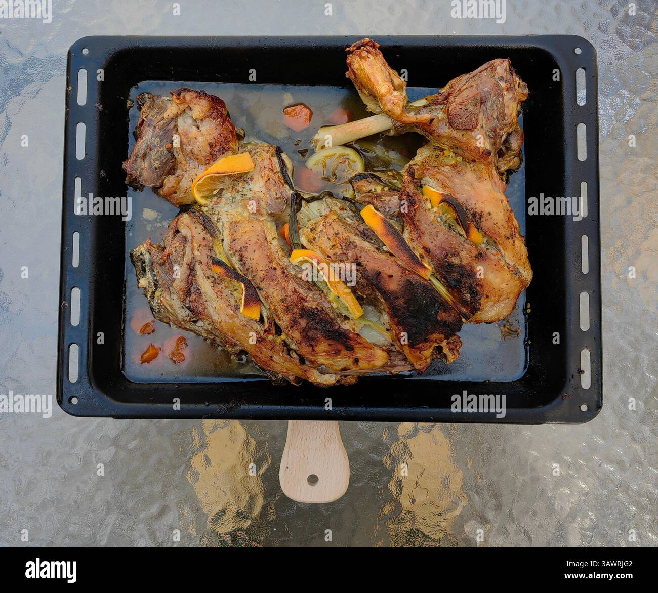 Arrosto di Pasqua: Agnello in padella nera su tavolo Crystal Matte Foto Stock