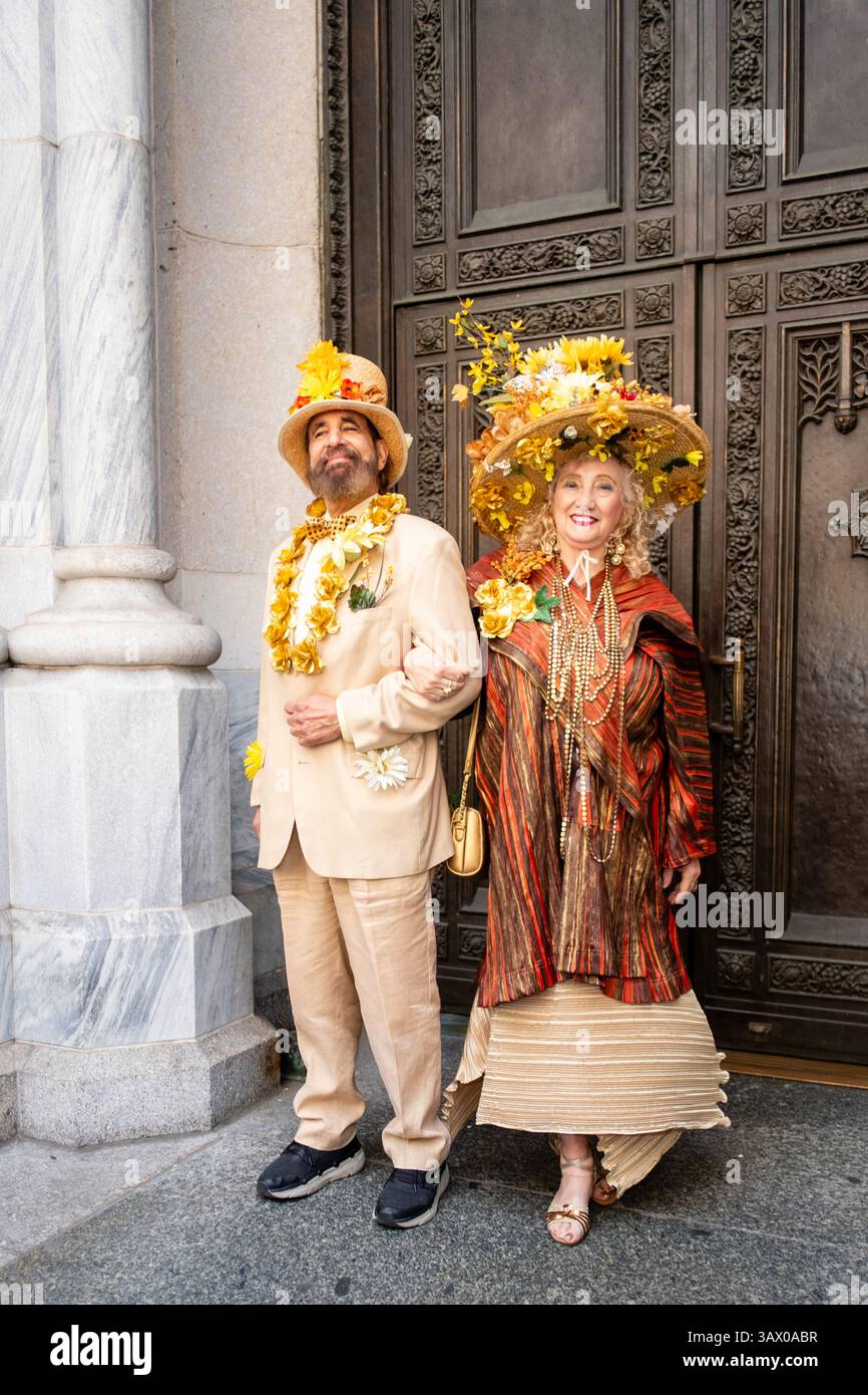 New York, New York, Stati Uniti. 20 aprile 2025. Una folla di coloratissimi e spesso fantasiosi finimenti si è rivelata in una calda giornata di primavera per l'annuale Easter Bonnet Parade and Festival di New York. Una coppia in costume di fronte alla porta della Cattedrale di San Patrizio. Crediti: Ed Lefkowicz/Alamy Live News Foto Stock