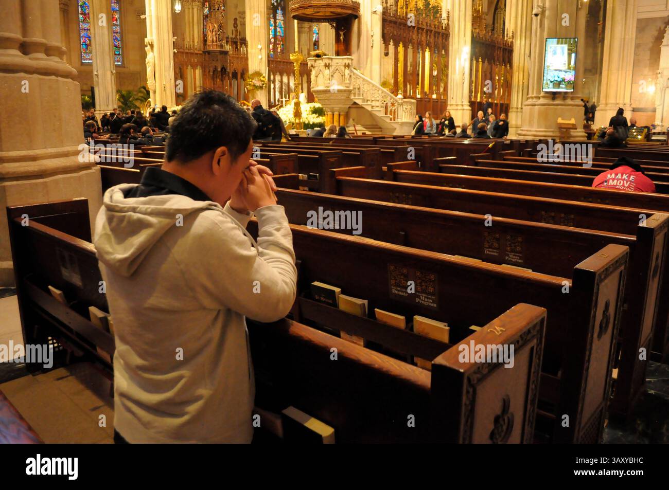 New York, Stati Uniti. 21 aprile 2025. Una persona prega nella cattedrale di San Patrizio. La cattedrale di San Patrizio ha tenuto una funzione commemorativa per Papa Francesco, morto lunedì 21 aprile all'età di 88 anni. I fedeli si riunirono nella cattedrale per rendere omaggio al defunto papa. La domenica di Pasqua, Papa Francesco ha salutato migliaia di fedeli in Piazza San Pietro. Il Vaticano ha detto che il papa è morto per un ictus che ha portato a coma e insufficienza cardiaca. Credito: SOPA Images Limited/Alamy Live News Foto Stock