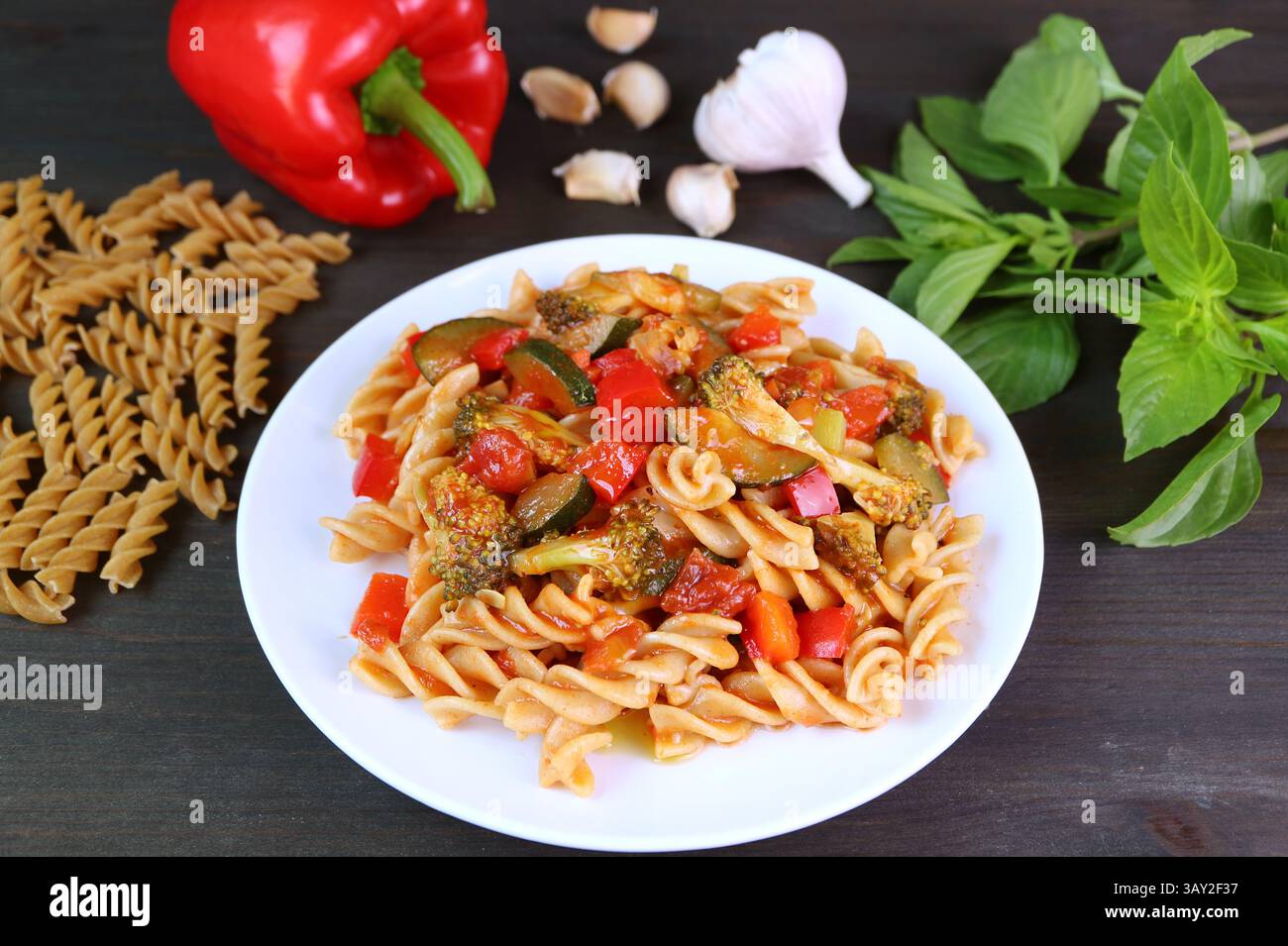 Piatto di Fusilli appena cucinato in salsa di pomodoro e condito con ingredienti Foto Stock