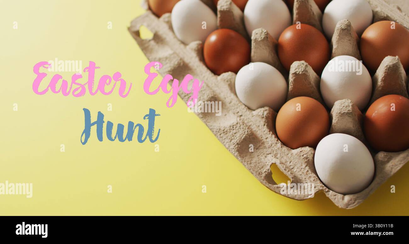Immagine della caccia all'uovo di pasqua sopra le uova in cartone su sfondo giallo Foto Stock