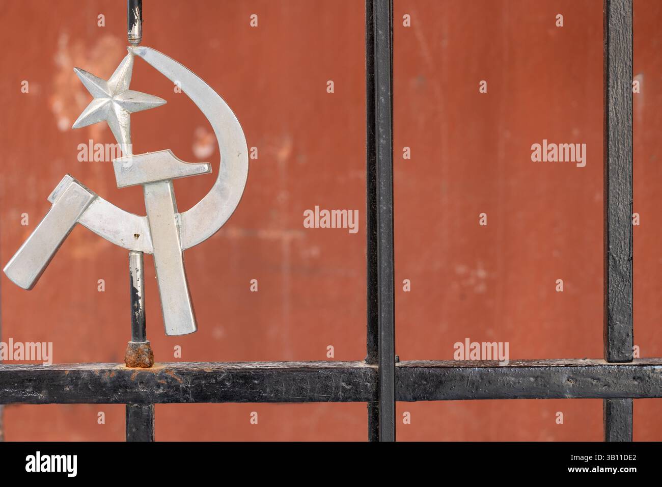 Venezia, Italia - 19 aprile 2025: Emblema del martello e della falce sulla recinzione all'ingresso dello spazio di incontro del movimento sociale Foto Stock