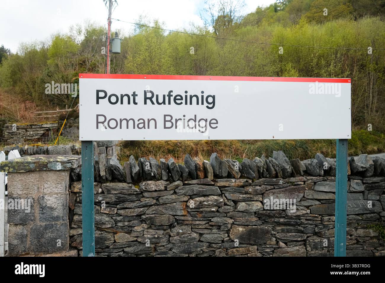 Un segno che dice Pont Rufeining e Roman Bridge. Stazione ferroviaria del parco nazionale di Snowdonia Foto Stock