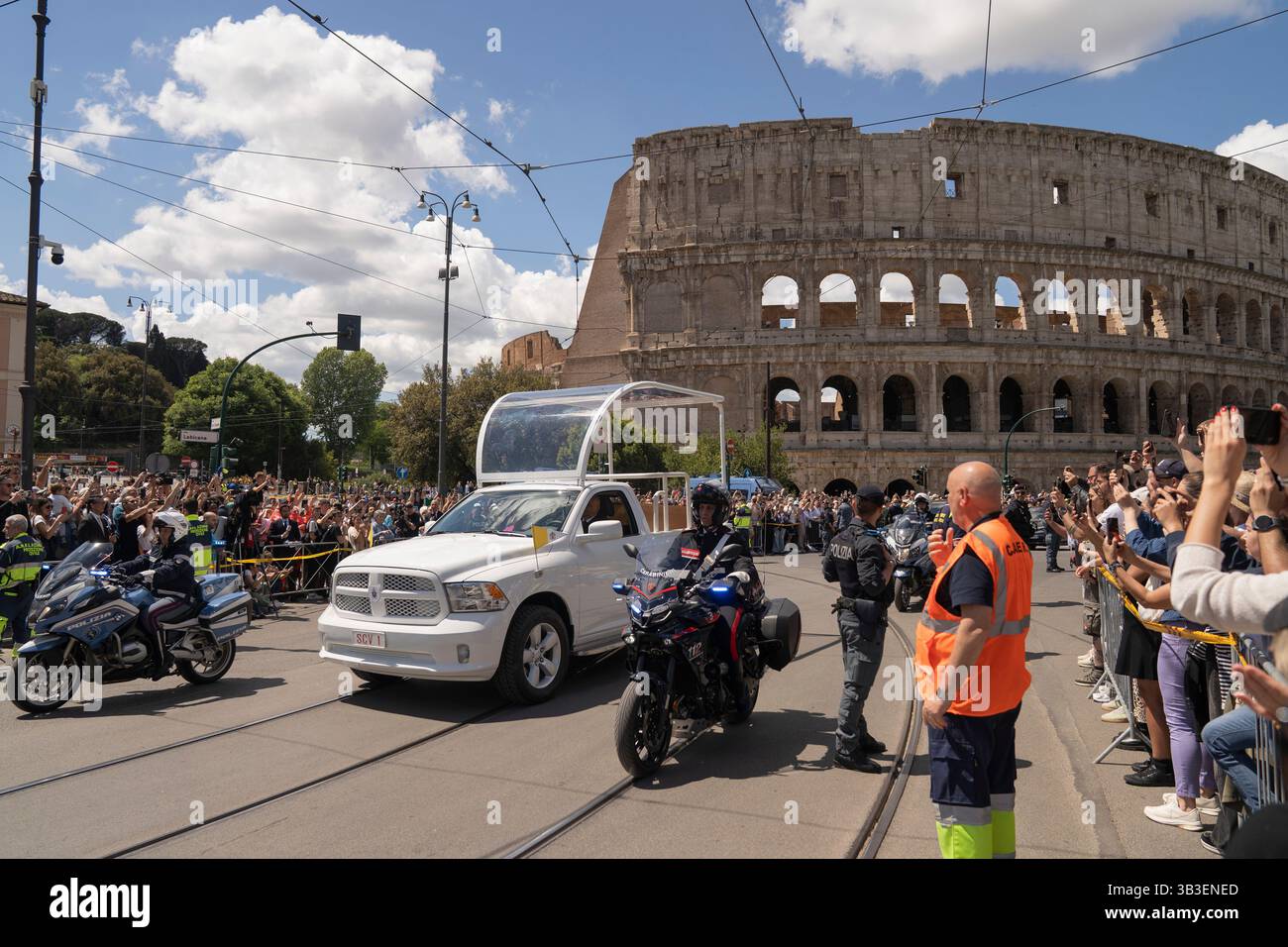 Un focolare che trasporta il corpo di Papa Francesco passa davanti al Colosseo durante la sua processione funebre lungo il tragitto per la sepoltura a Santa Maria maggiore a Roma, Italia. Foto Stock