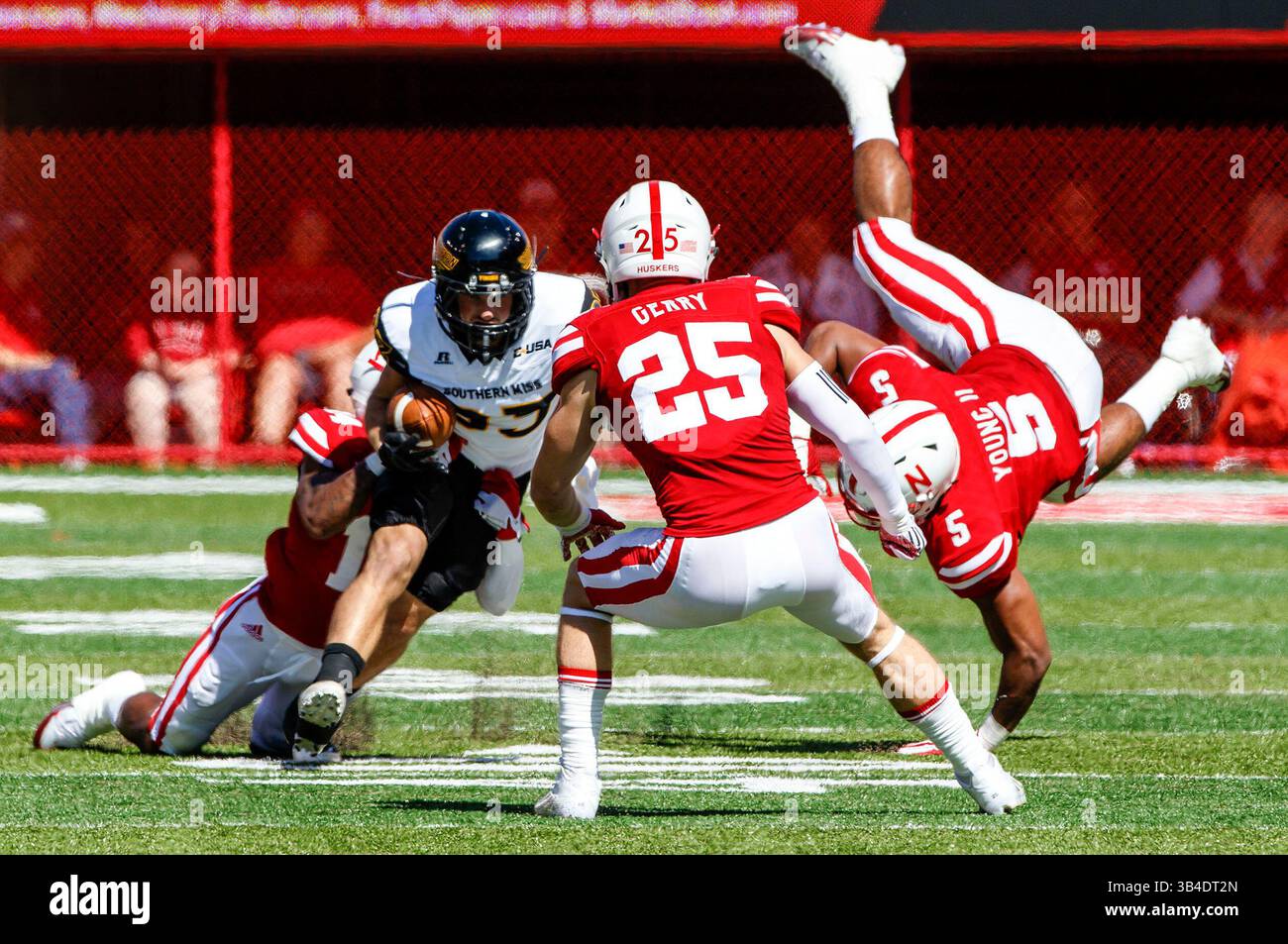 26 settembre 2015 - Lincoln, Nebraska. Stati Uniti - il running back Southern Miss Golden Eagles Ito Smith #25 trascina un placcatore del Nebraska mentre il linebacker dei Nebraska Cornhuskers Dedrick Young #5 vola in aria e la sicurezza Nate Gerry #25 ti aspetta in azione durante una partita di football della NCAA Division 1 tra i Southern Mississippi Golden Eagles e Nebraska Cornhuskers al Memorial Stadium di Lincoln, Nebraska...Nebraska ha vinto il 36-28.presenze: 89,899.Michael Spomer/Cal M.com. Foto Stock