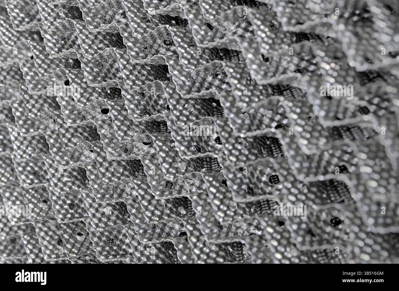 Filtro in acciaio o griglia di separazione dei liquidi, primo piano, messa a fuoco selettiva, sfondo industriale astratto Foto Stock