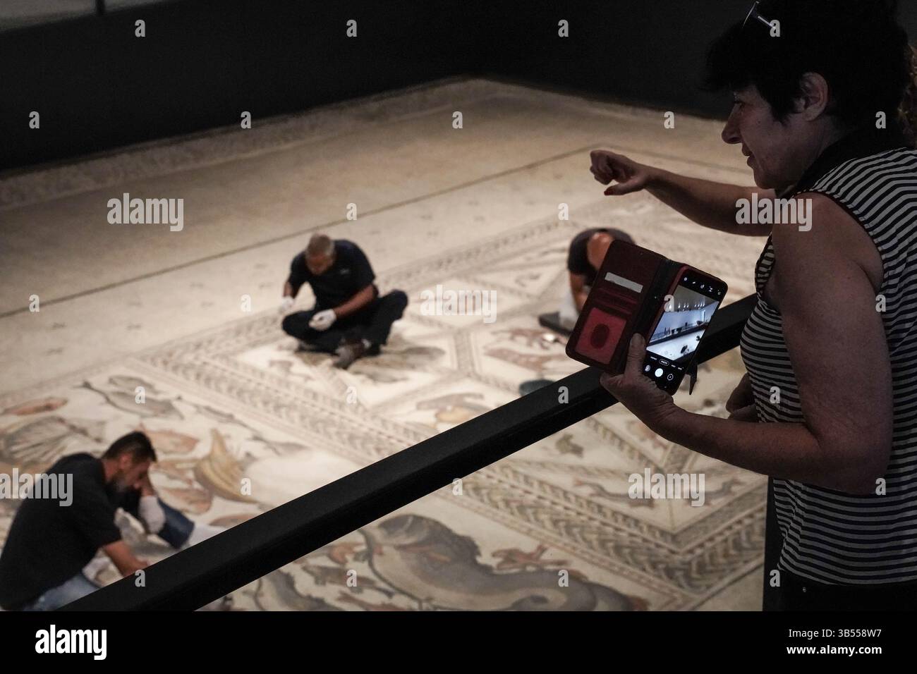 27 giugno 2022, Lod, Israele: I lavoratori conducono operazioni di pulizia all'ultimo minuto prima che l'Autorità delle Antichità israeliana inauguri il Centro Archeologico del mosaico di Shelby White e Leon Levy Lod. L'obiettivo del centerÂ è quello di esporre un mosaico di 1.710 piedi quadrati di epoca romana (dal III al IV secolo d.C.) che serviva come pavimento di una villa da soggiorno in un ricco complesso abitativo di Lod. Il mosaico, ritenuto dagli archeologi straordinario per la sua qualità, il suo soggetto raffigurato e la sua conservazione, viene definito un gioiello archeologico con immagini di mammiferi, uccelli, pesci, piante varie e antiche navi depiche Foto Stock