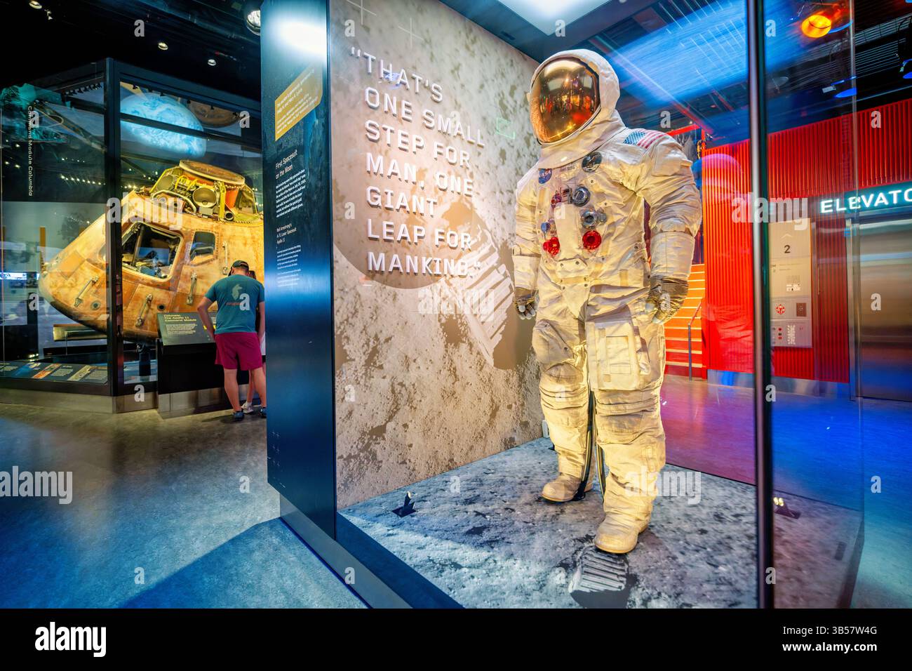 Smithsonian National Museum of Air and Space sul National Mall Washington DC | WASHINGTON D.C., Stati Uniti — la tuta spaziale A7L di Neil Armstrong si trova nella galleria "Destination Moon" del National Air and Space Museum, con il modulo di comando dell'Apollo 11 Columbia bruciato visibile dietro vetro. Armstrong indossò questa tuta durante la prima passeggiata lunare il 20 luglio 1969. È stato rimesso in mostra nel 2019, dopo che i lavori di conservazione sono stati programmati per il 50 ° anniversario della missione. Foto Stock
