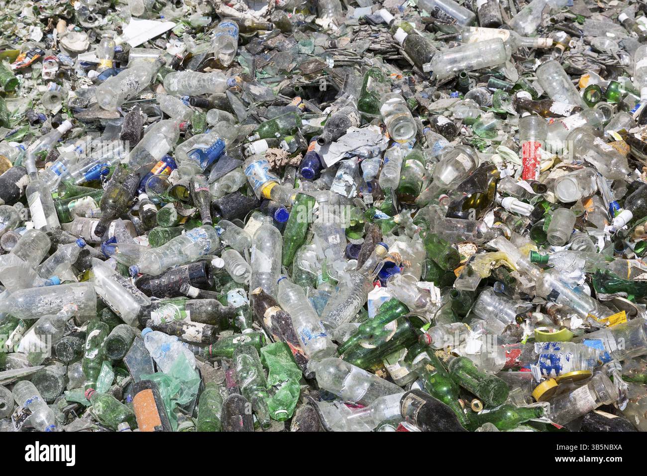 Rifiuti di vetro per il riciclaggio in un impianto di riciclaggio. Diversi imballaggi in vetro bottiglia rifiuti. Rifiuti di vetro di gestione. Processo di rifiuti in vetro utilizzabile Foto Stock