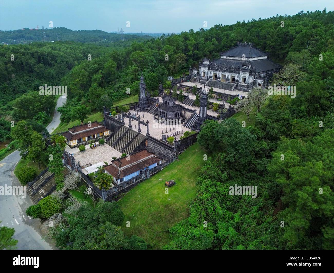 Il Mausoleo di Khai Dinh vicino a Huế fonde tradizione vietnamita e influenza europea in un monumento di pietra scura situato tra le colline. Foto Stock