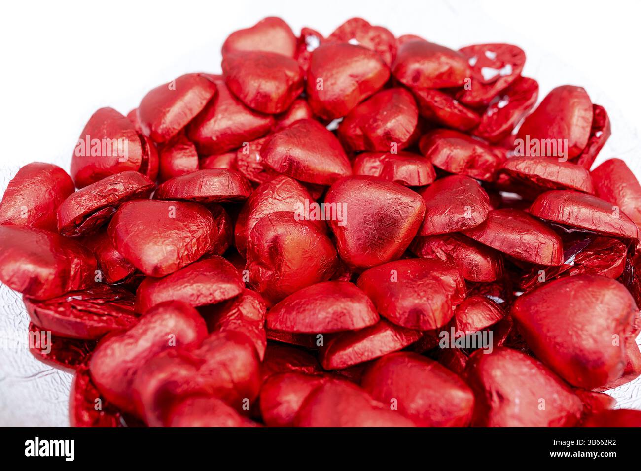 Tanti cioccolatini rossi a forma di cuore, cuori rossi, cioccolato per San Valentino Foto Stock
