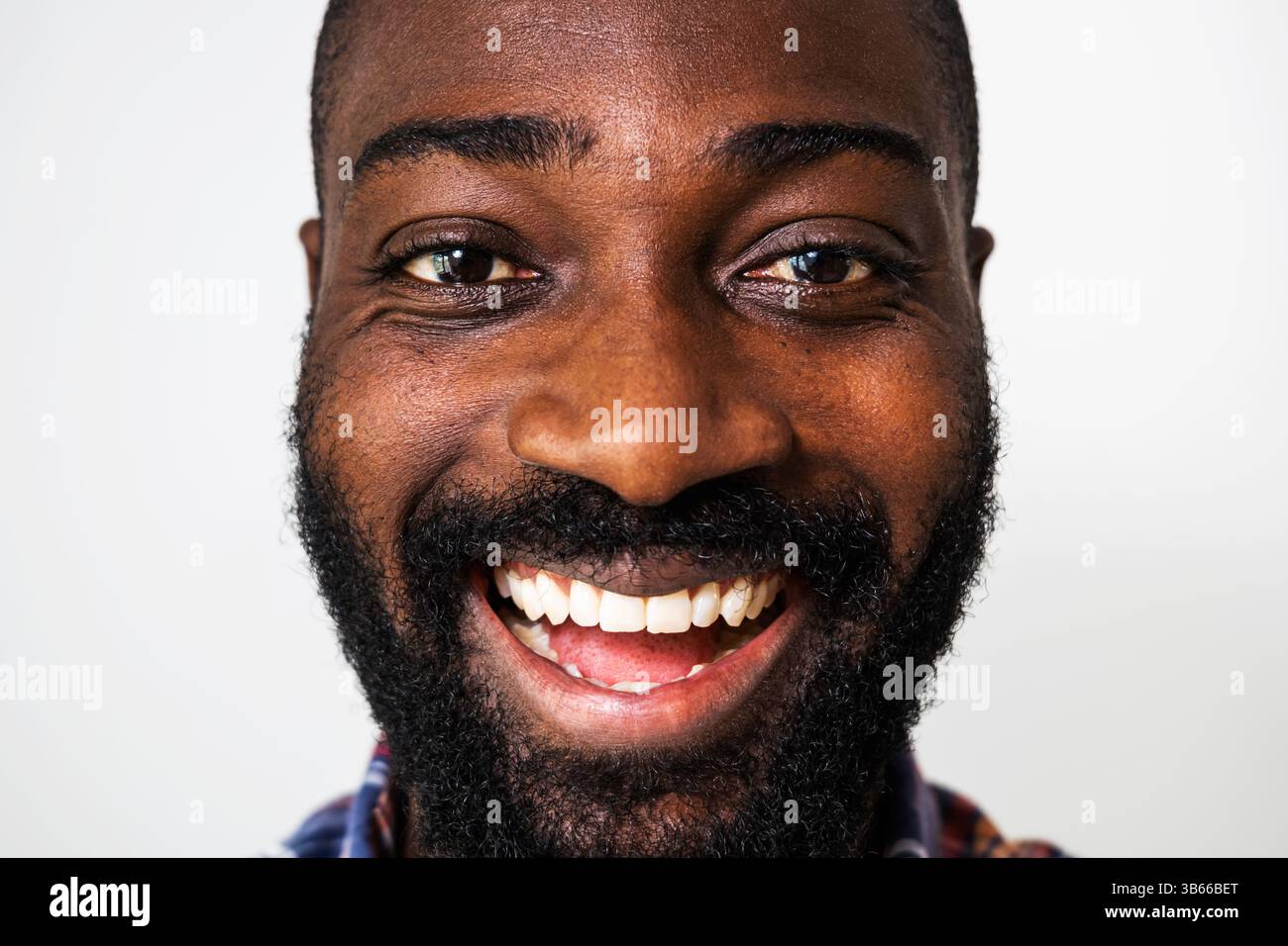 Primo piano ritratto di un uomo nero felice e allegro. L'uomo adulto sta ridendo. Foto Stock