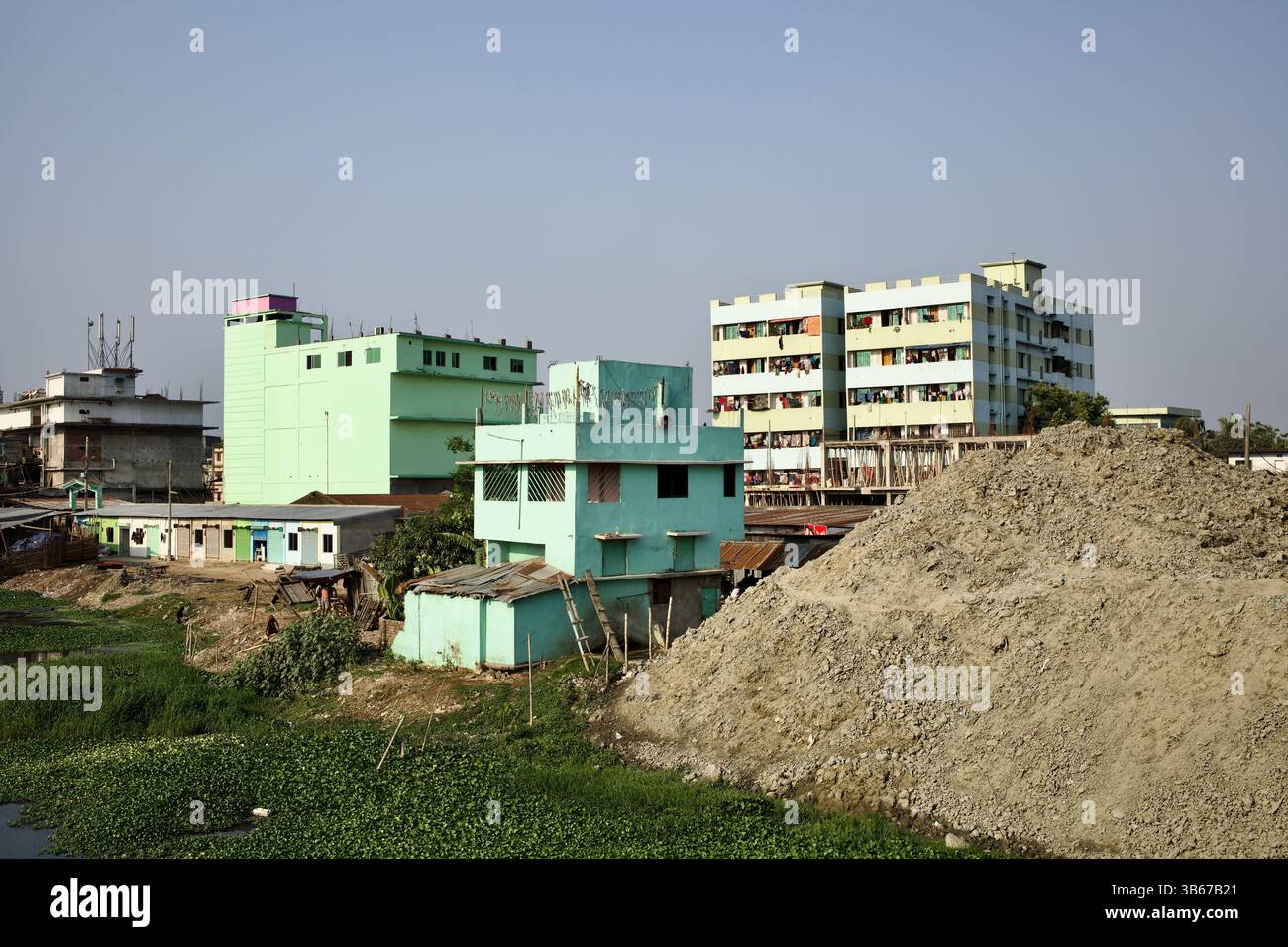 L'invasione urbana e i lavori di miglioramento del canale convergono vicino al fiume Karnaphuli a Chittagong, vicino al ponte Shah Amanat, Bangladesh. Foto Stock