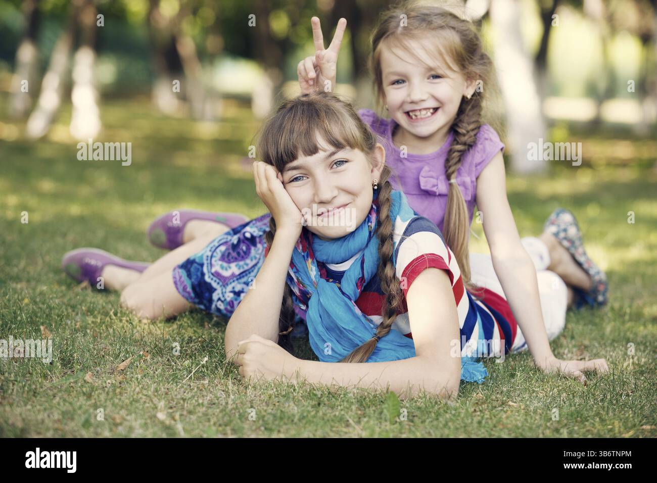 Ragazze divertenti che giacciono sull'erba Foto Stock