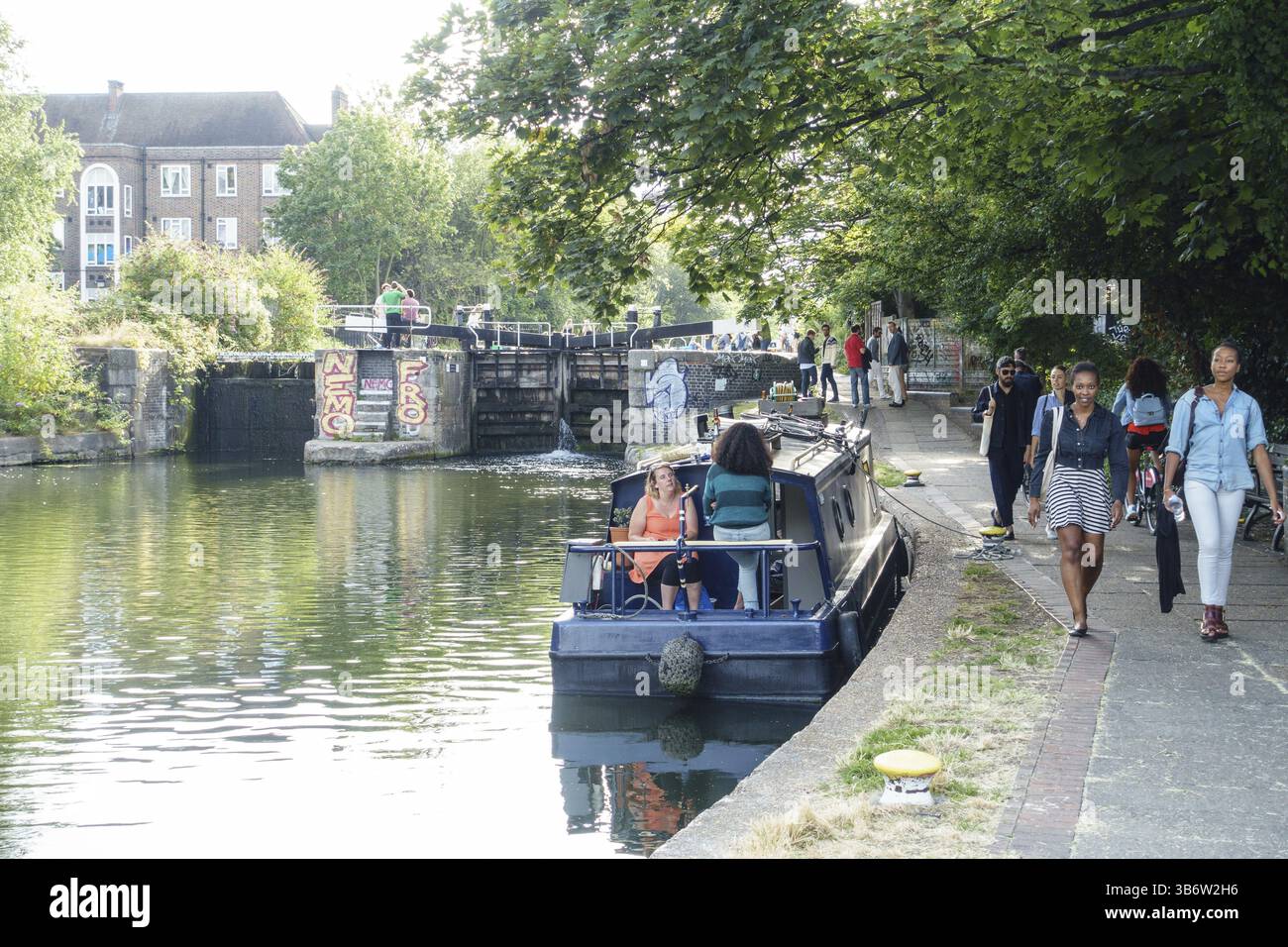 Persone che trascorrono un fine settimana di sole nell'estate 2015 vicino a un canale nella zona est di Londra Foto Stock