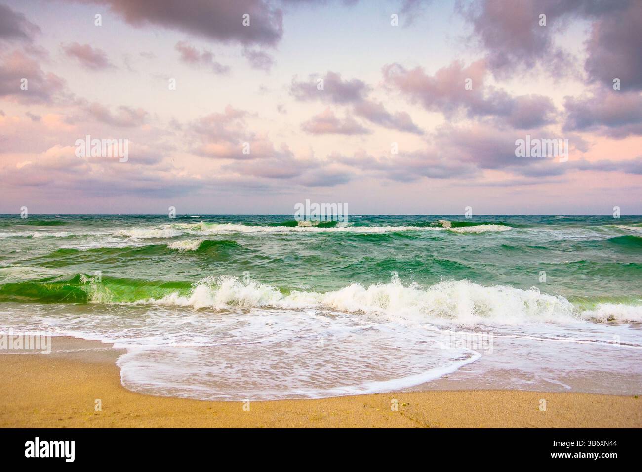 cielo sereno nuvoloso al mare nero. onde ondulate. il tempo cambia in natura. bellissimo paesaggio arancione. vacanze estive spettacolari in europa al b Foto Stock