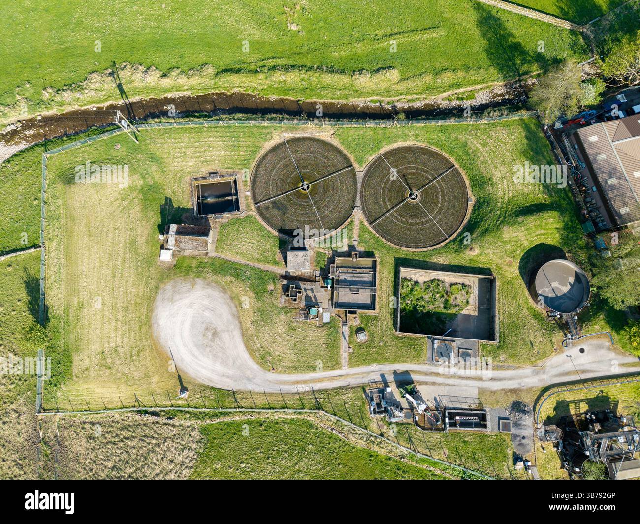 Il trattamento delle acque reflue si svolge lungo un fiume ai margini di una piccola città commerciale nel Yorkshire Dales National Park, Regno Unito. Foto Stock
