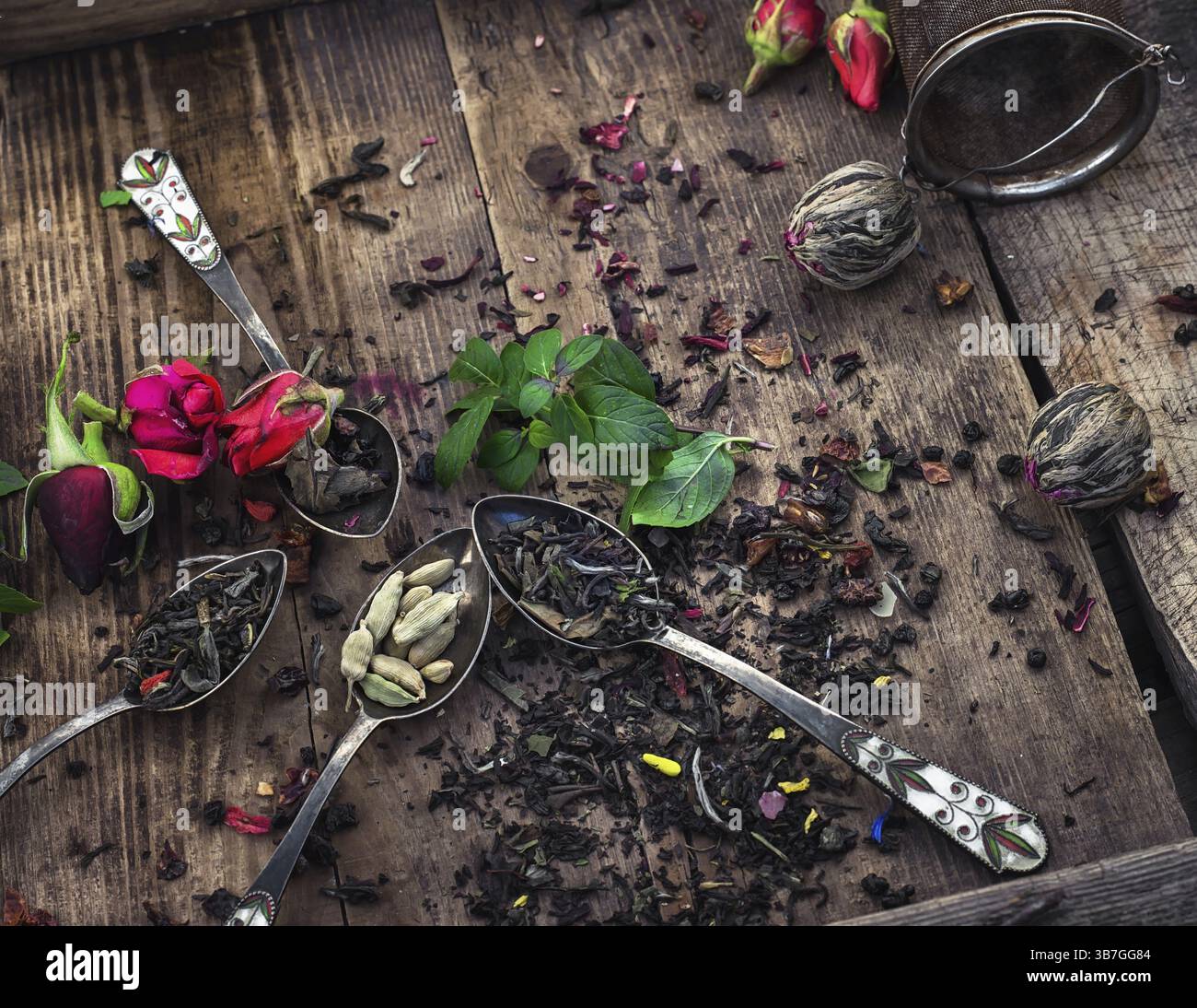 Asciugare brew tea in vintage e cucchiai su sfondo di legno Foto Stock