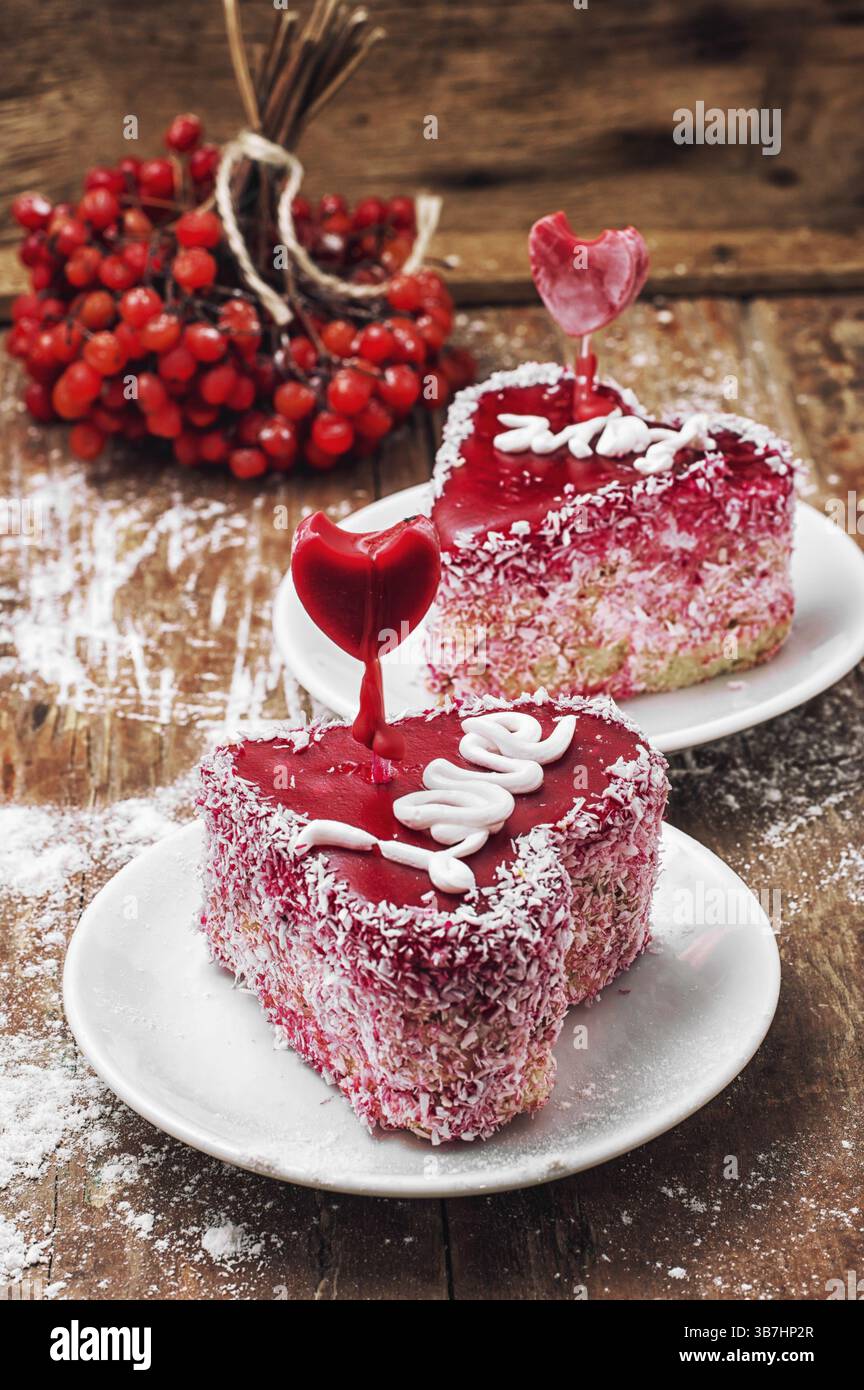 Torta a forma di cuore con l'iscrizione amore e mazzo di frutti di bosco di viburnum Foto Stock