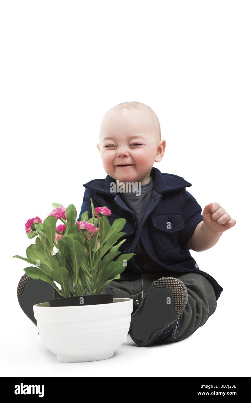 Ragazzo divertente con la pianta della casa Foto Stock