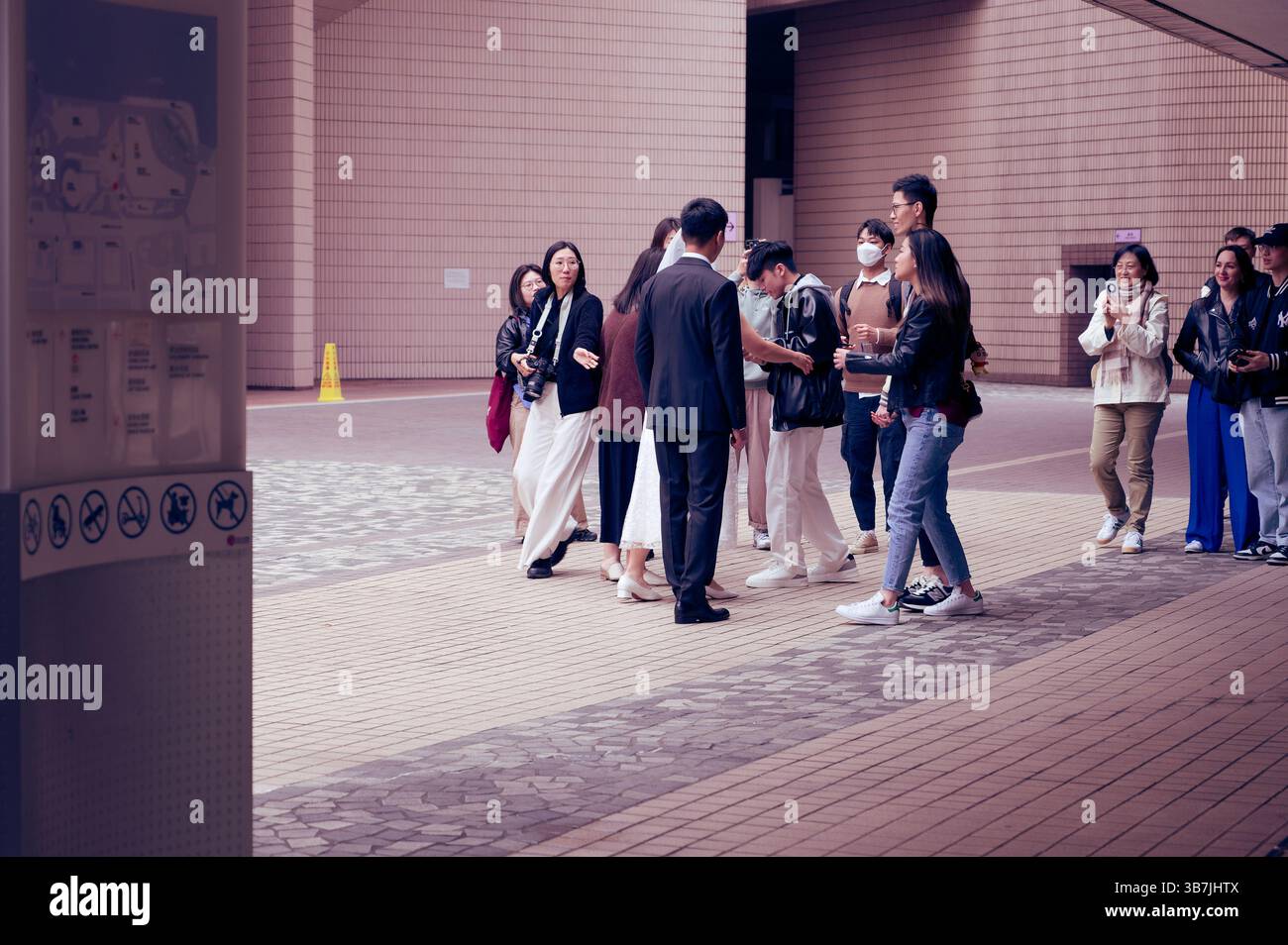 Un paio di persone che chiedono indicazioni per le foto di matrimonio fuori dall'Hong Kong Cultural Centre Foto Stock