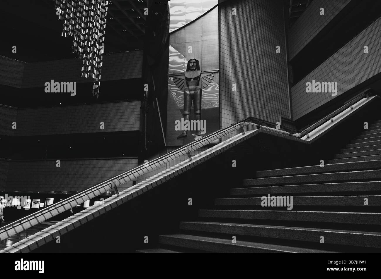 Una suggestiva scultura alata si erge sopra le scale piastrellate del Centro culturale di Hong Kong Foto Stock