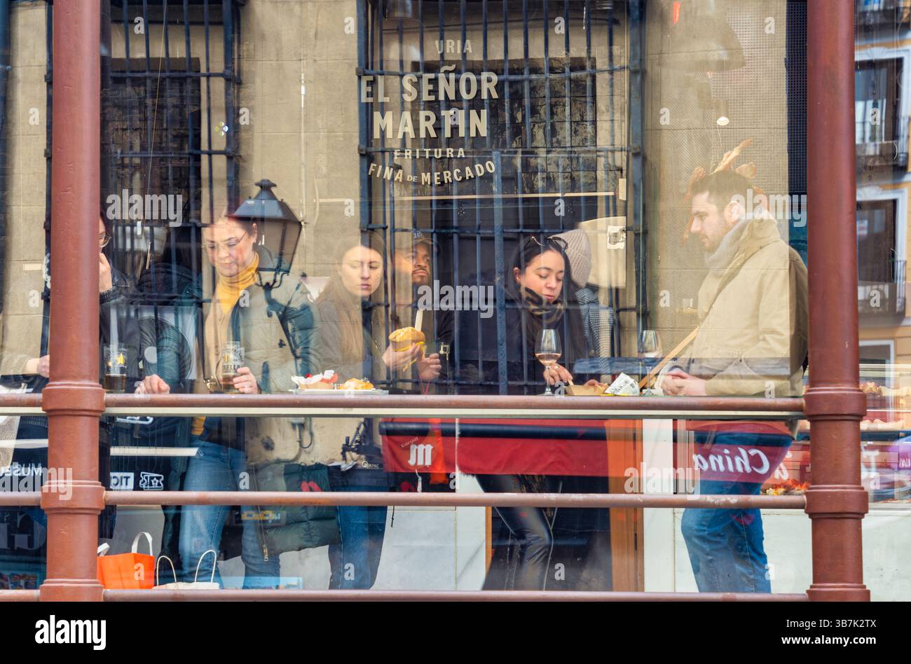 Madrid, Spagna - 03.10.2025: Persone che gusteranno cibo e bevande al Mercado de San Miguel. Foto Stock