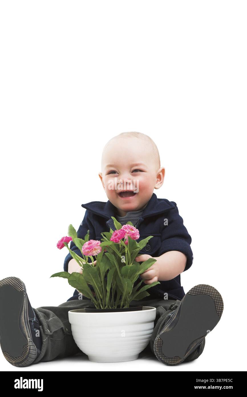 Ragazzo divertente con la pianta della casa Foto Stock
